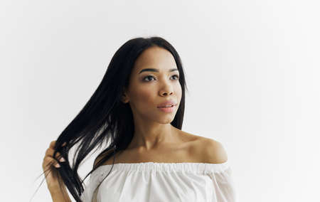 Pretty African woman appearance white dress attractive appearance light backgroundの写真素材