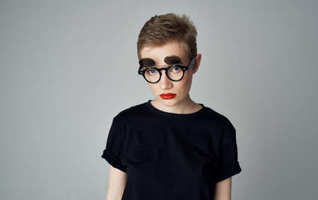Woman with short hair and dark glasses makeup red lips glamor close-upの写真素材