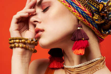 attractive woman in colorful mist decoration red backgroundの写真素材