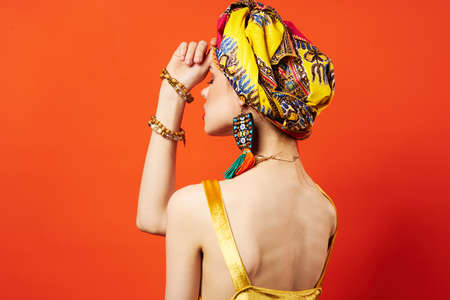 woman wearing multicolored turban decoration attractive look ethnicity red background