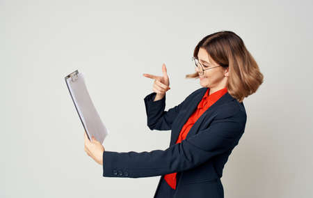 Business woman in a blue jacket with documents in hands emotions work officeの写真素材