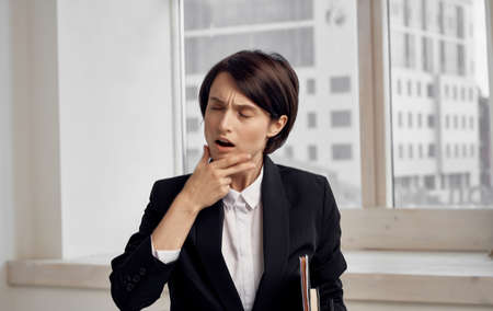 finance model woman in black jacket with documents in hands