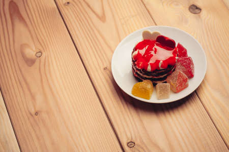 red cake street sweets marmalade tea cup wooden table dessertの写真素材