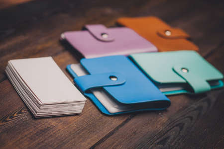 bright business card holders and a pack of white paper on a wooden background close-upの写真素材