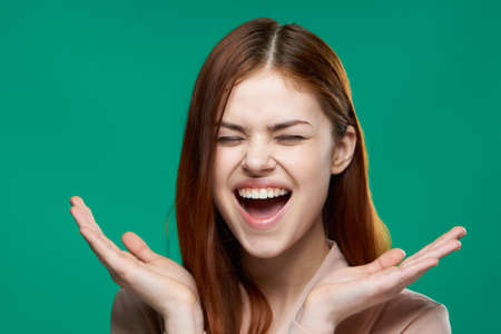 emotional woman surprised look emotions hand gestures green backgroundの写真素材
