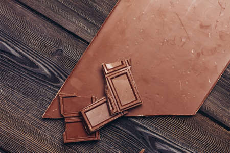 broken chocolate bar diagonal cubes texture wood backgroundの写真素材