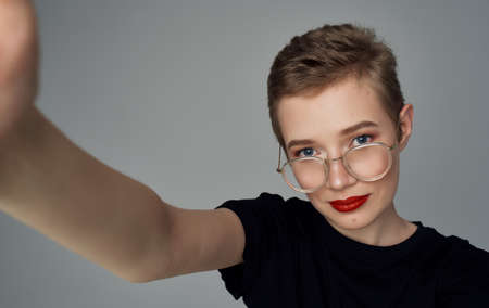 Pretty woman from short haircut and red lips black t-shirt smile modelの写真素材