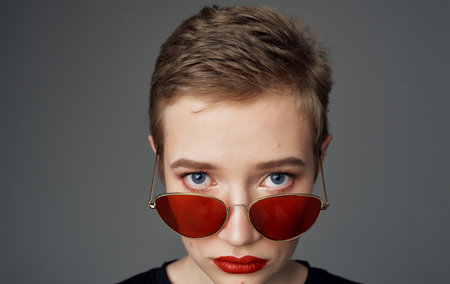 Pretty woman dark glasses makeup red lips short hair close-up
