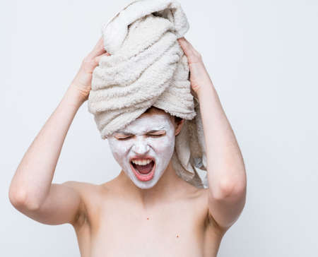 woman with bare shoulders face mask skin care cropped view studioの写真素材