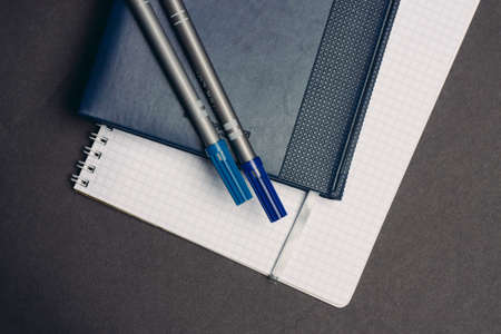 notebook books pens documents workplace office gray background
