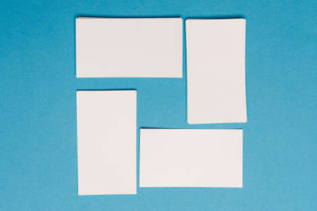white business cards mockup placed randomly on the office desk
