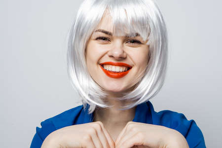 pretty blonde red lips emotions hands near face cropped view isolated backgroundの写真素材