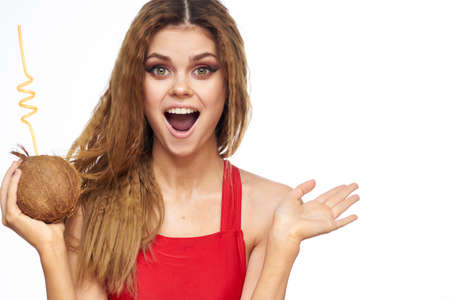 Beautiful woman with coconut cocktail in hands wavy hair cosmetics attractive look lifestyle leisure