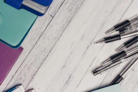 stationery business card holders colored pencils pens on wooden table office suppliesの写真素材