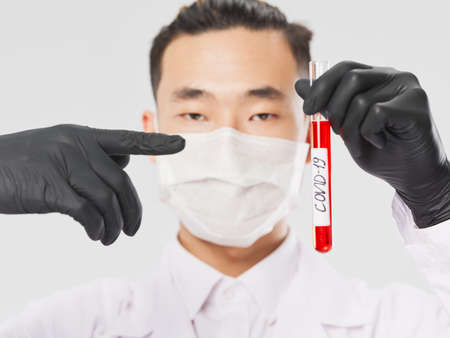 male doctor in black gloves blood test covid-19 close-up