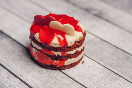 red round cake on a saucer sweets dessert snack wooden background