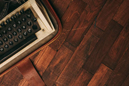 vintage typewriter with white paper stands on the floor indoors top view