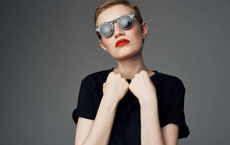 Woman with short hair and dark glasses makeup red lips glamor close-up