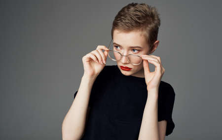 Pretty woman with short hair in glasses red lips attractive view close-up