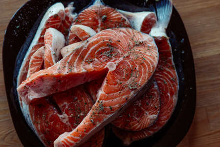 red fish marinated on a plate wooden background cooking