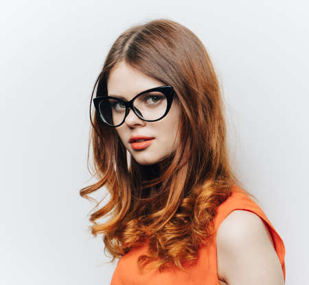 pretty woman in orange sundress and glasses makeup portraitの写真素材