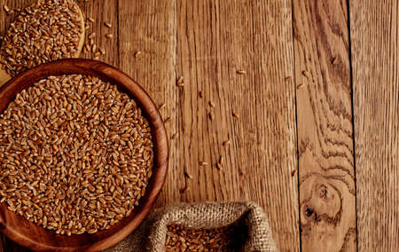Wheat sprinkled on a wooden table texture image cereal food preparationの写真素材