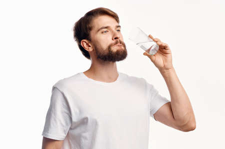 handsome guy with a glass of water on a white background t-shirt cropped view Modelの写真素材
