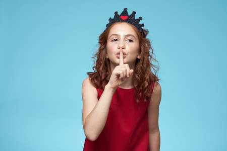 Girl in red dress with curly hair fun lifestyle blue background