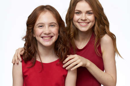 Joyful family fun mom daughter emotions light backgroundの写真素材