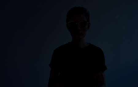 Woman with short hair dark glasses elegant style hairdresser gray backgroundの写真素材