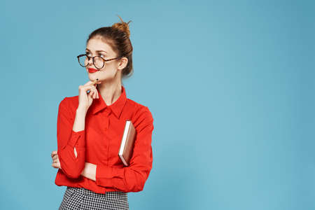 Elegant woman wearing glasses red shirt notepad secretary Studioの写真素材