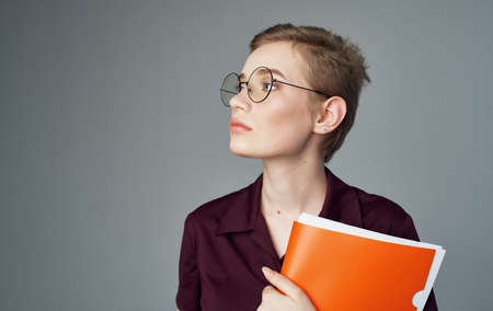 Woman secretary documents in hands of glasses short hairstyle business womanの写真素材