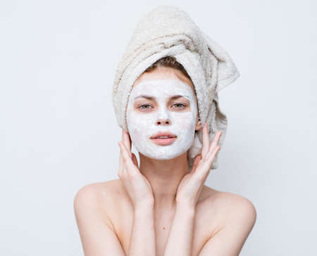 woman with bare shoulders face mask clean skin careの写真素材
