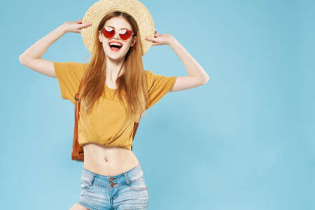 Cheerful pretty woman in hat and sunglasses hair backpack emotions lifestyleの写真素材