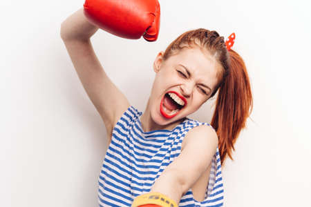 Strong woman in boxing gloves and striped t-shirt aggression cropped view emotionの写真素材