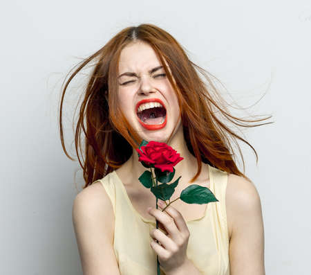 emotional woman with rose flower displeasure cry isolated backgroundの写真素材