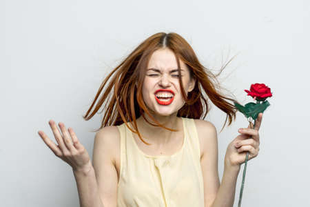 woman red hair cosmetics face rose flower holiday charmの写真素材