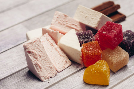 multicolored marmalade and sweets dessert snack wooden backgroundの写真素材