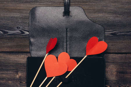 leather business card holder red heart ornament decoration wooden tableの写真素材