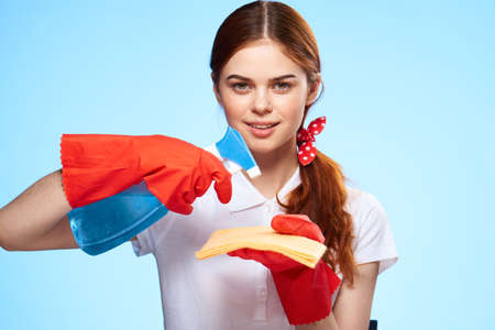 professional cleaning lady detergent with a rag in her hands working like blue backgroundの写真素材