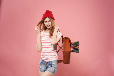 Cheerful woman fashion clothes backpack studio pink background
