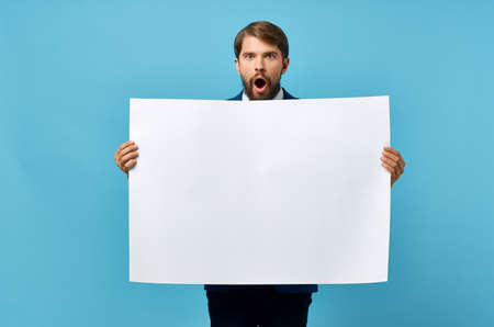bearded man holding white mockup Poster Copy Space blue backgroundの写真素材
