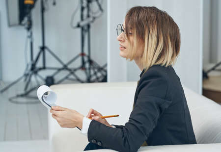 Woman sofas In a bright room studio white sofa modelの写真素材
