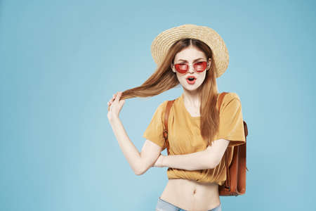 Cheerful pretty woman in hat and sunglasses hair backpack emotions lifestyleの写真素材