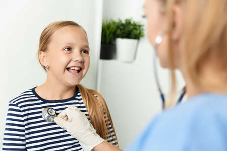 funny little girl in the hospital examination treatmentの写真素材