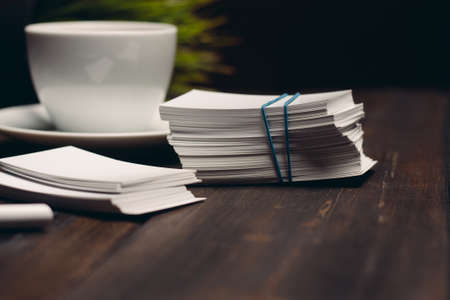 coffee cup on the table business cards office desktop business documentsの写真素材