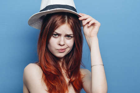 pretty woman in hat naked shoulders red hair emotions fashion