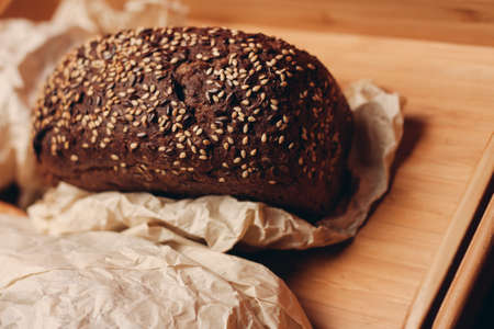 loaf of bread flour product wooden board tray and paper packaging