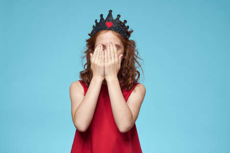 Girl in red dress with curly hair fun lifestyle blue background