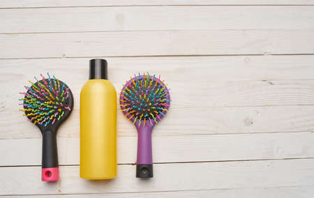 Yellow jar of cream and combs on a wooden table background image